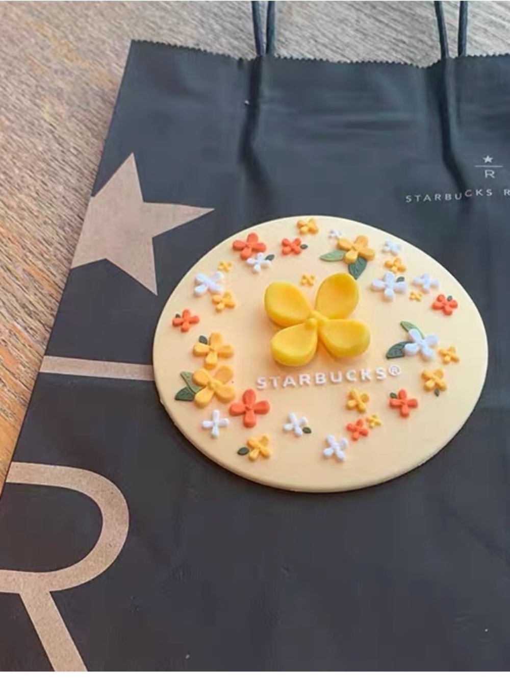 Starbucks Cream Silicone Trivet with Yellow and Orange Floral Accents mug lid